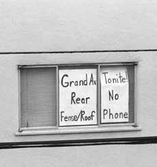 Sign in Oakland apartment window.